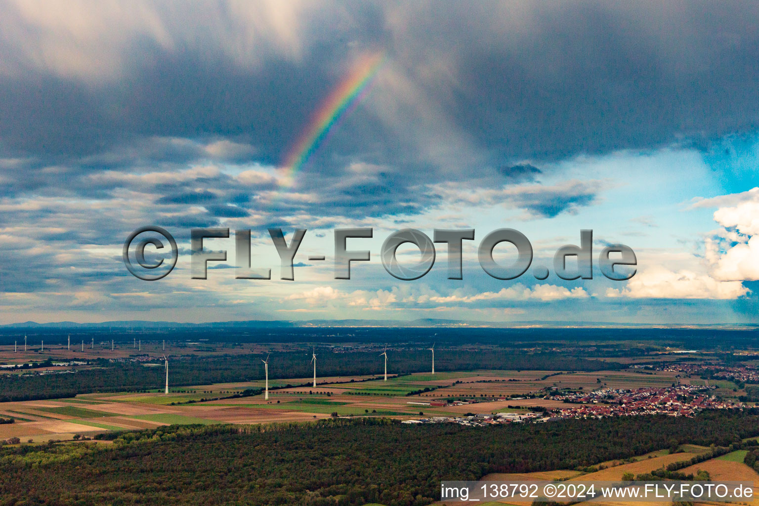 Aerial view of Rainbow over the wind turbines at Hatzenbühl in Hatzenbühl in the state Rhineland-Palatinate, Germany