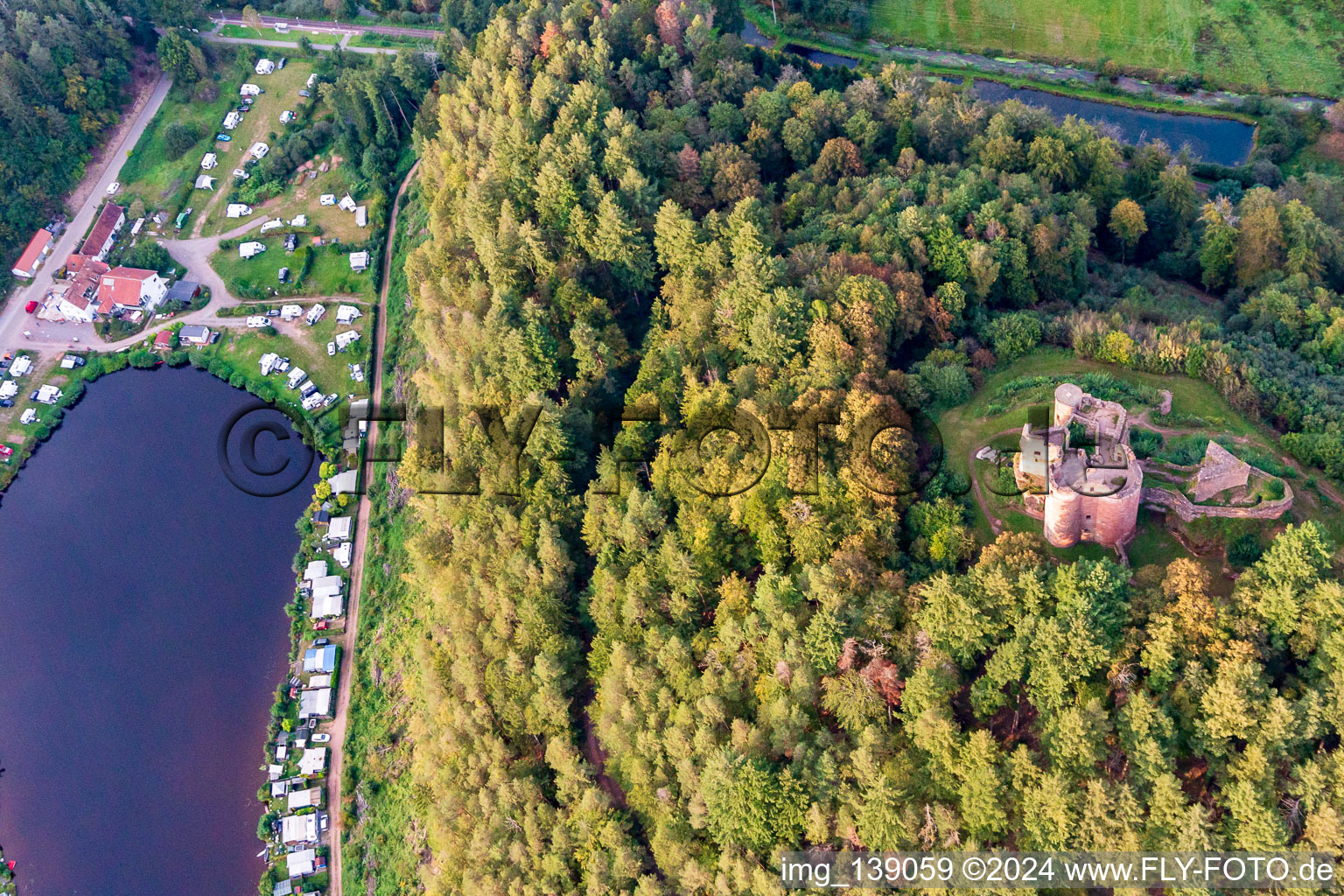 Neudahn Castle ruins above the Neudahner Weiher campsite in Dahn in the state Rhineland-Palatinate, Germany from the plane