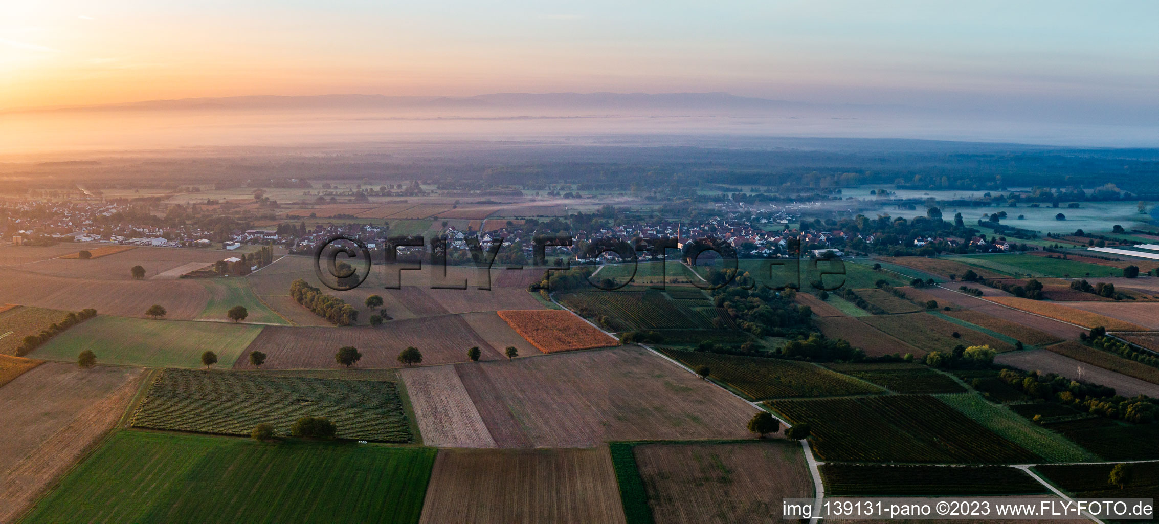 From the north in the morning mist in Kapsweyer in the state Rhineland-Palatinate, Germany