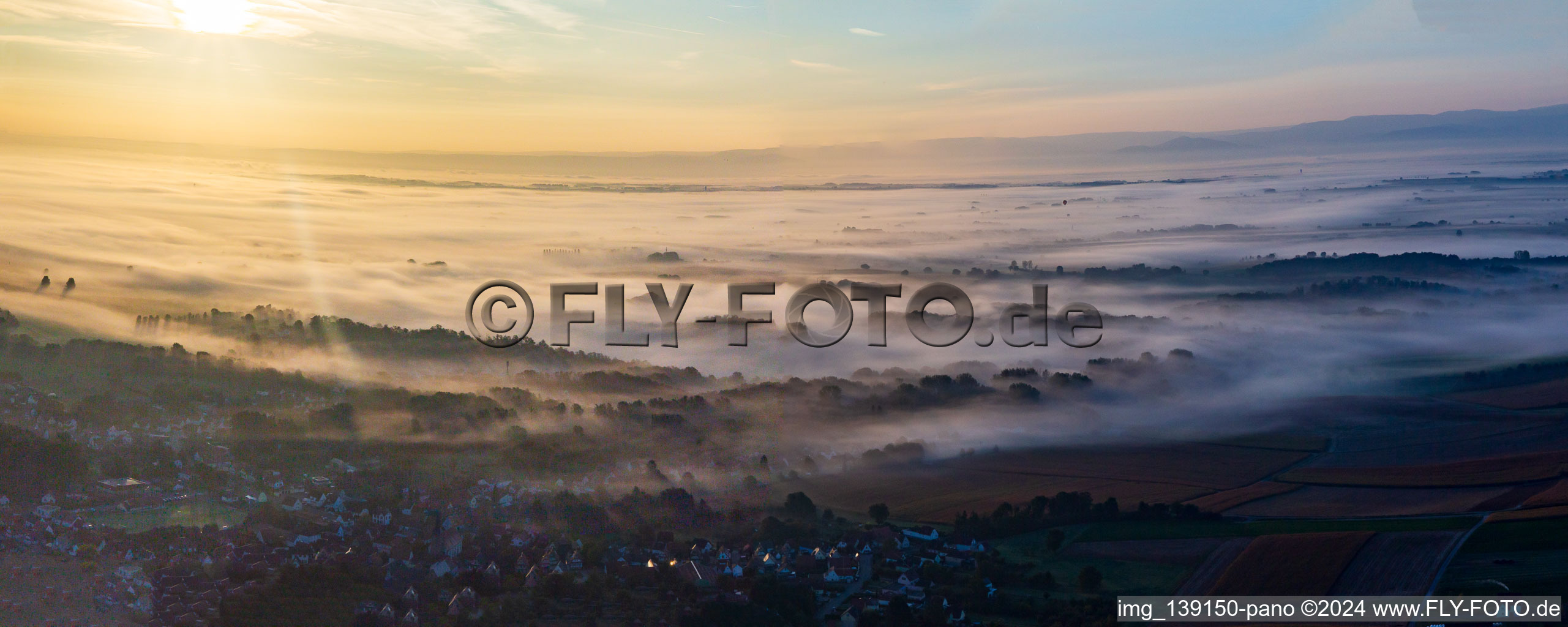 Fog and hot air balloon over the Rhine plain in northern Alsace in Riedseltz in the state Bas-Rhin, France