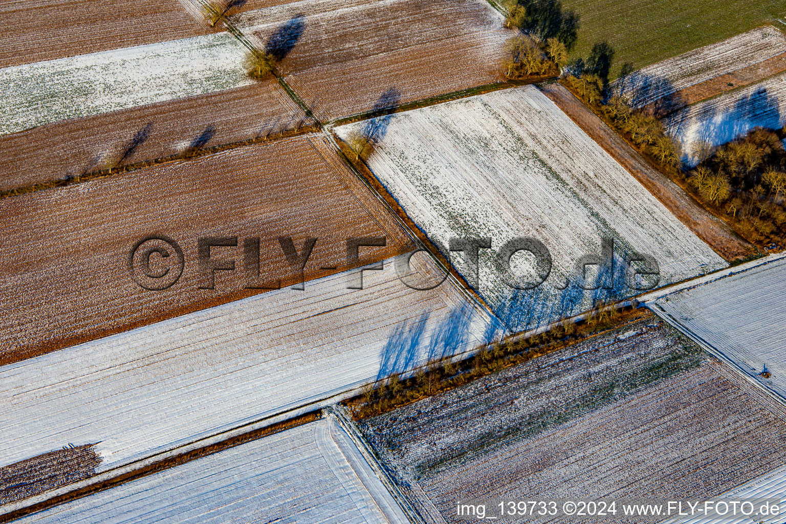 Field structures and shadows in winter with snow in Schweighofen in the state Rhineland-Palatinate, Germany