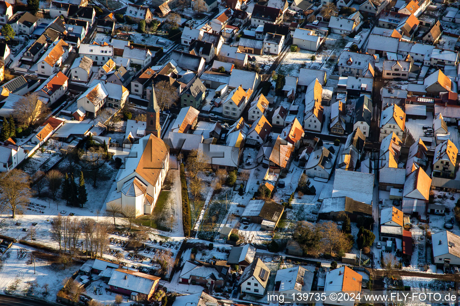 Parish church of St. Ulrich in winter with snow in Kapsweyer in the state Rhineland-Palatinate, Germany