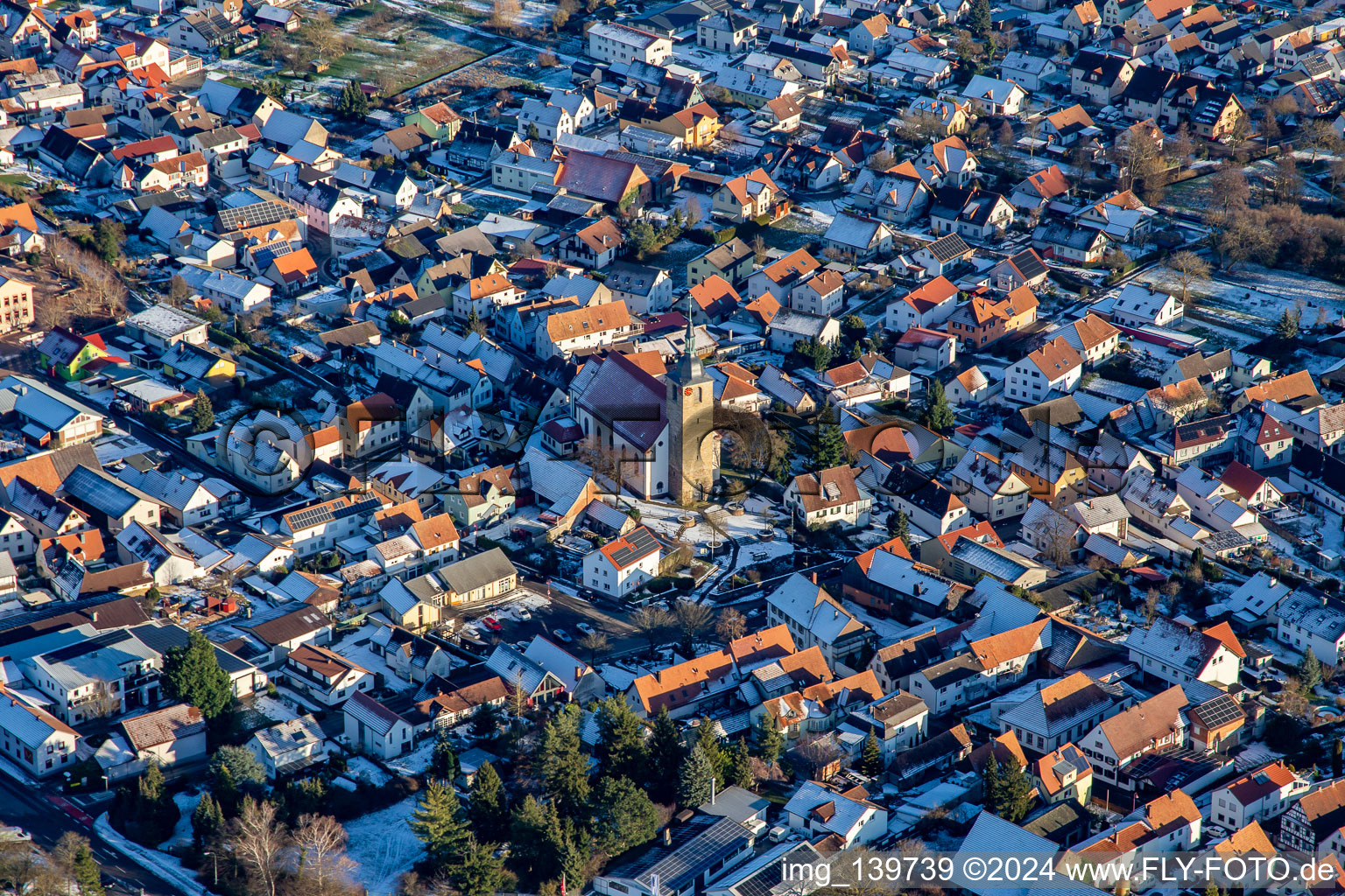 Catholic Church of St. Leodegar in winter with snow in Steinfeld in the state Rhineland-Palatinate, Germany