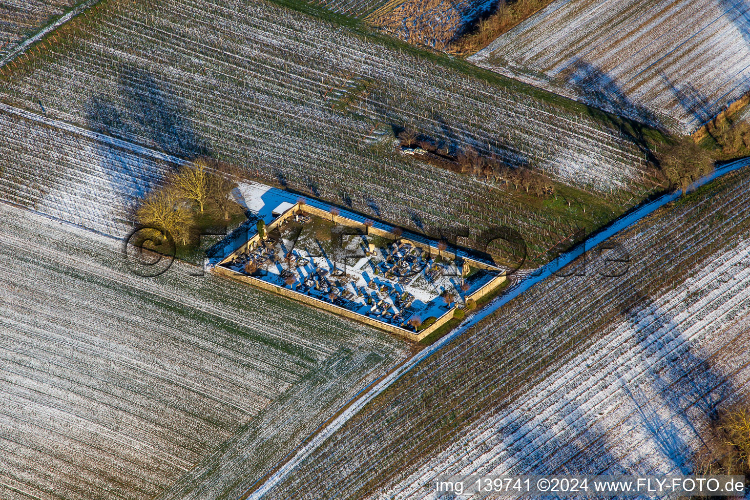 Cemetery in winter with snow in the district Kleinsteinfeld in Niederotterbach in the state Rhineland-Palatinate, Germany