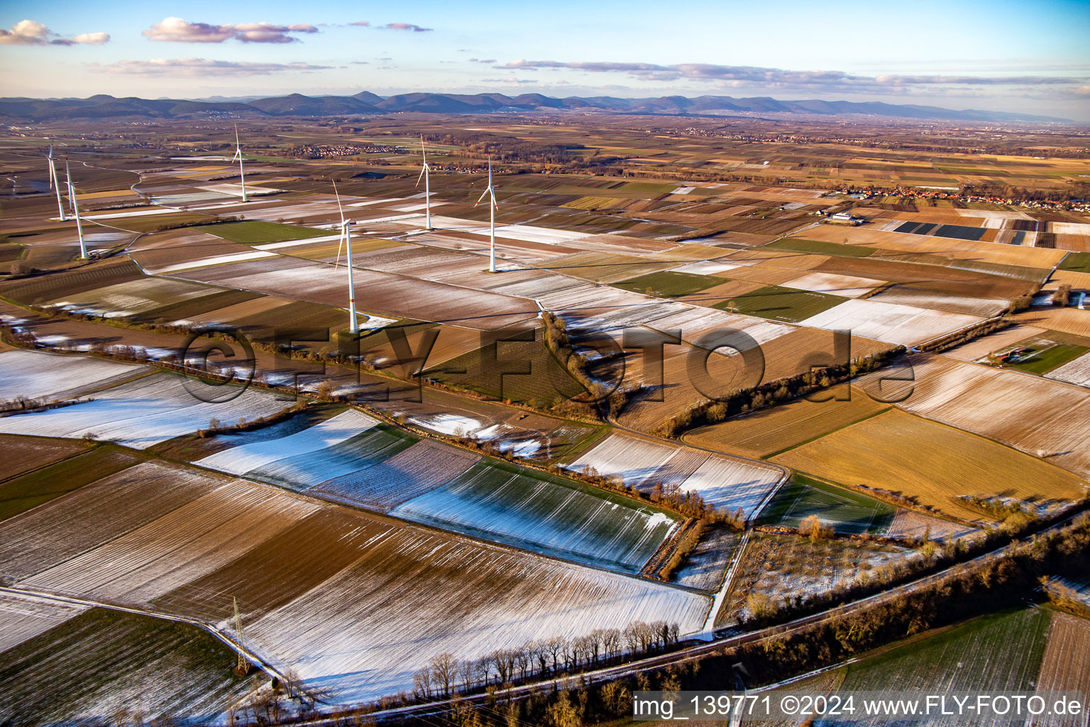 Field structures and shadows in winter with snow at the wind farm Freckenfeld in Freckenfeld in the state Rhineland-Palatinate, Germany