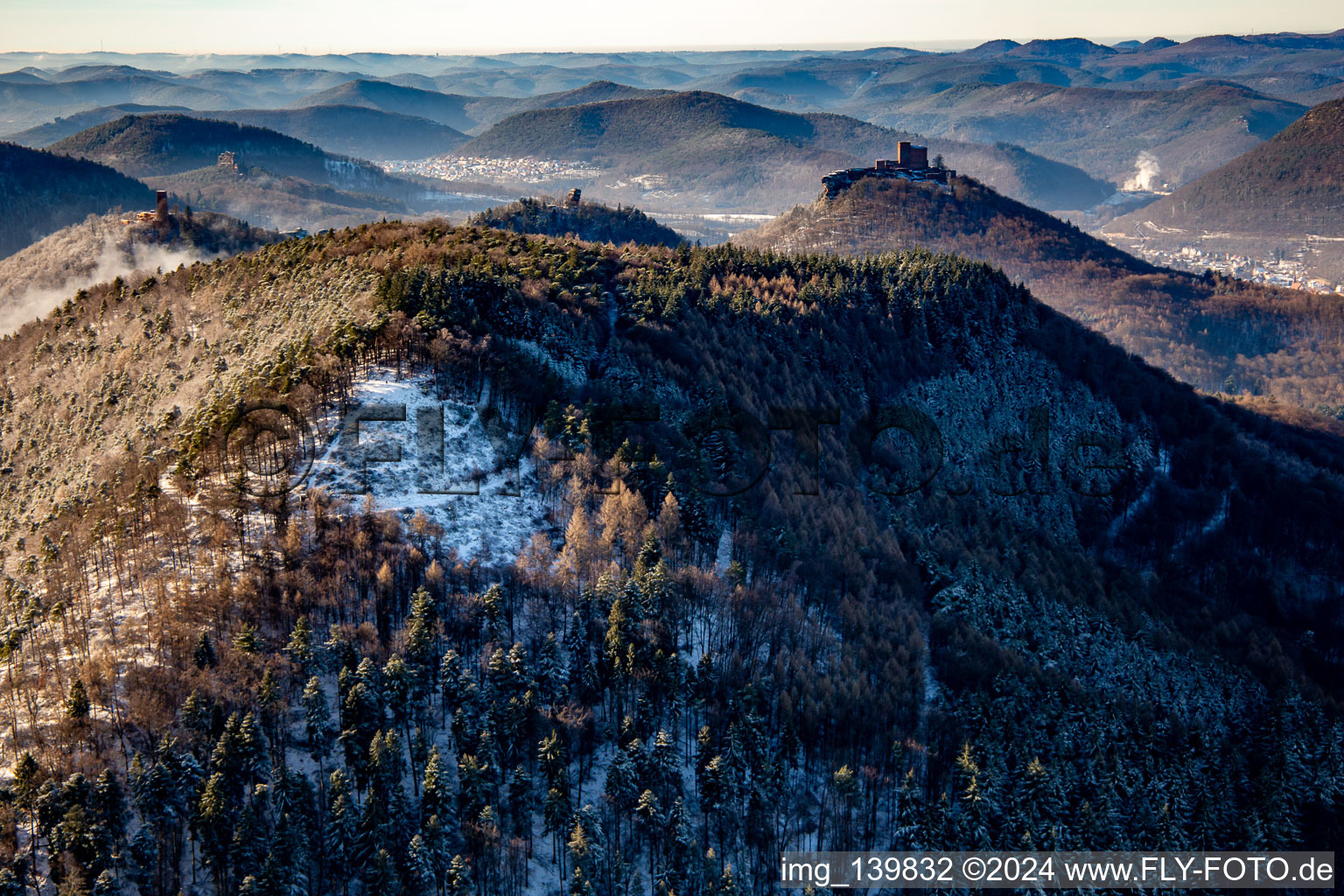 Trifels Castle, Anebos and Scharfenberg castle ruins behind the Förlenberg paragliding launch site in winter with snow in Leinsweiler in the state Rhineland-Palatinate, Germany