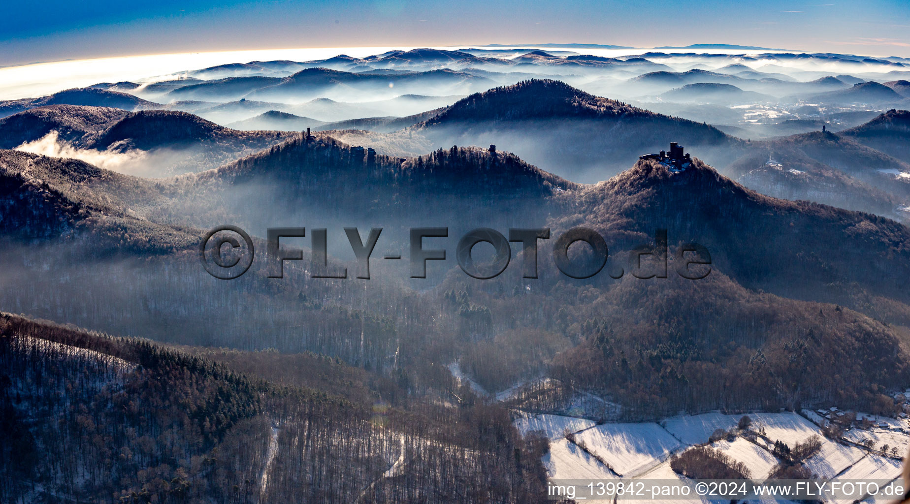 Trifels Castle, Anebos and Scharfenberg castle ruins from the northeast in winter with snow in Annweiler am Trifels in the state Rhineland-Palatinate, Germany