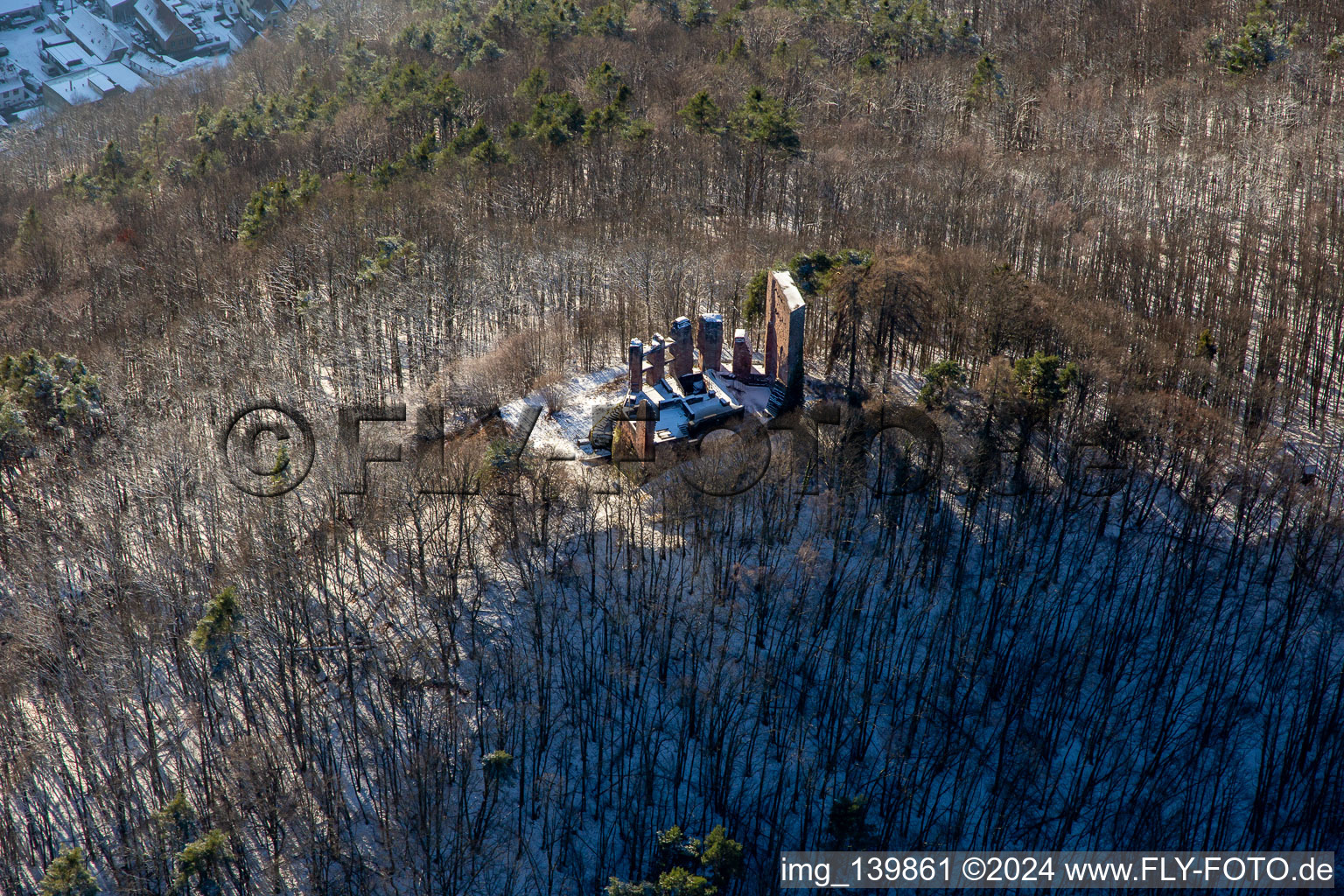 Aerial view of Ramburg castle ruins in winter with snow in Ramberg in the state Rhineland-Palatinate, Germany