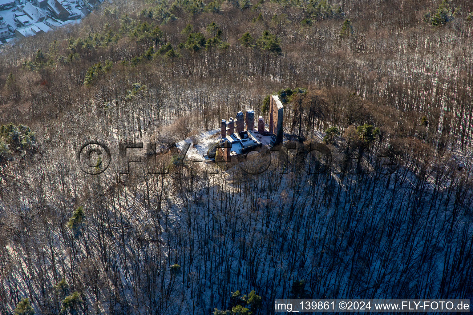 Aerial view of Ramburg castle ruins in winter with snow in Ramberg in the state Rhineland-Palatinate, Germany