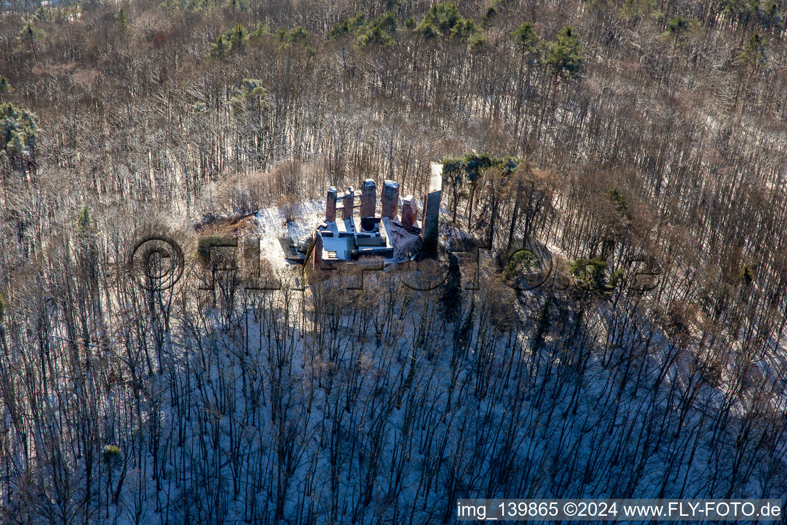 Oblique view of Ramburg castle ruins in winter with snow in Ramberg in the state Rhineland-Palatinate, Germany