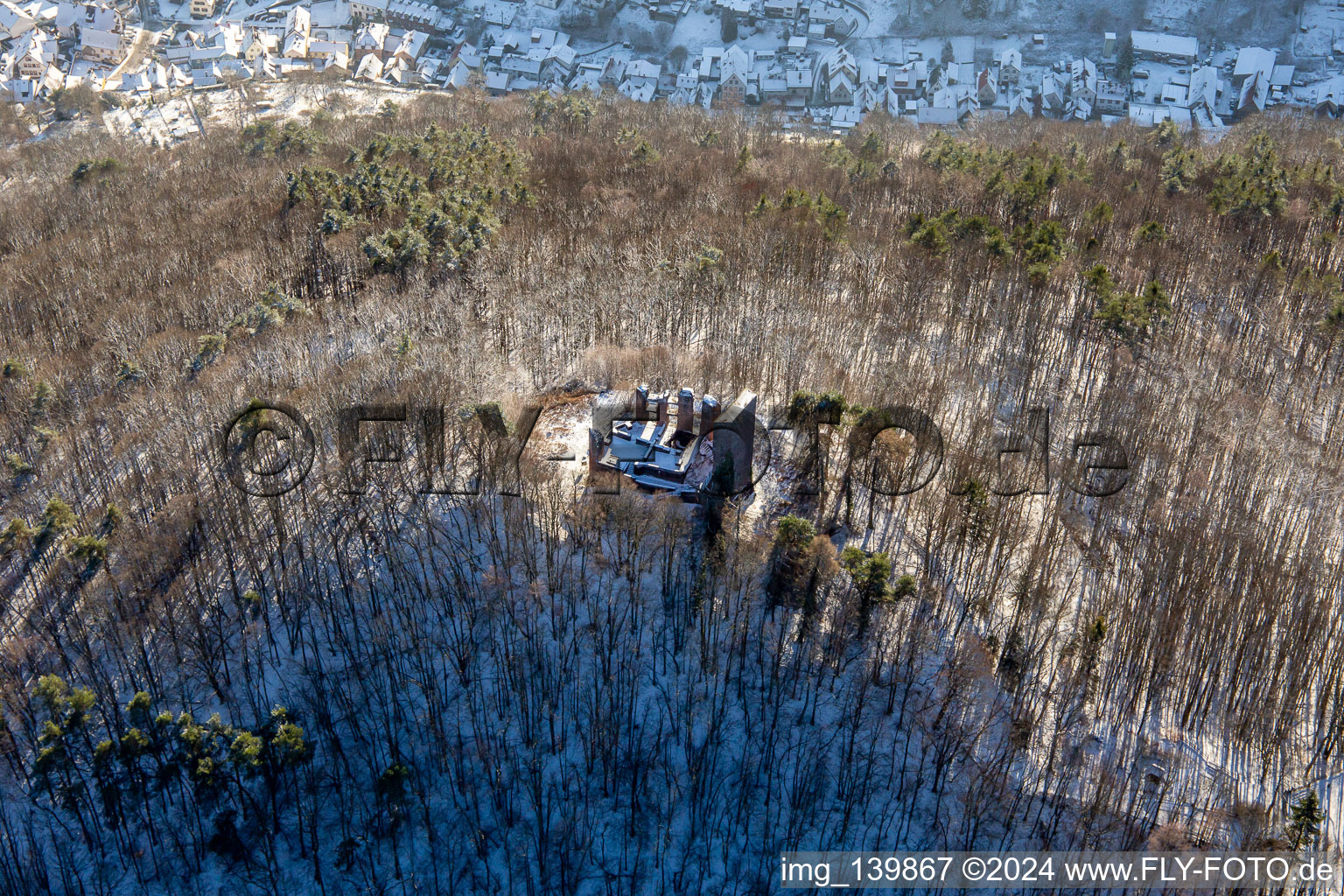 Ramburg castle ruins in winter with snow in Ramberg in the state Rhineland-Palatinate, Germany out of the air