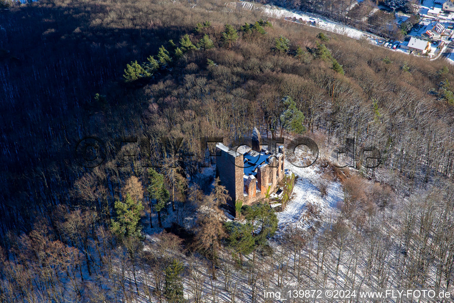 Ramburg castle ruins in winter with snow in Ramberg in the state Rhineland-Palatinate, Germany from the plane