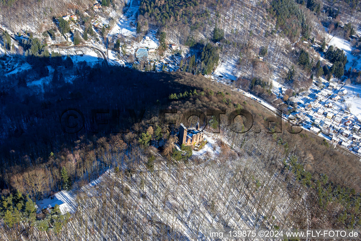 Bird's eye view of Ramburg castle ruins in winter with snow in Ramberg in the state Rhineland-Palatinate, Germany