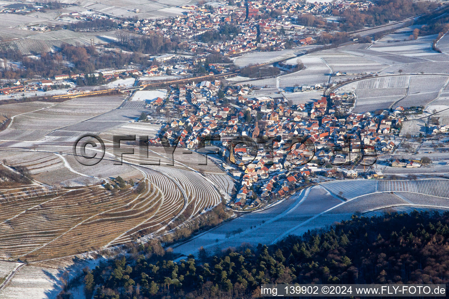 Aerial photograpy of Keschdebusch vineyard from the west in winter with snow in Birkweiler in the state Rhineland-Palatinate, Germany