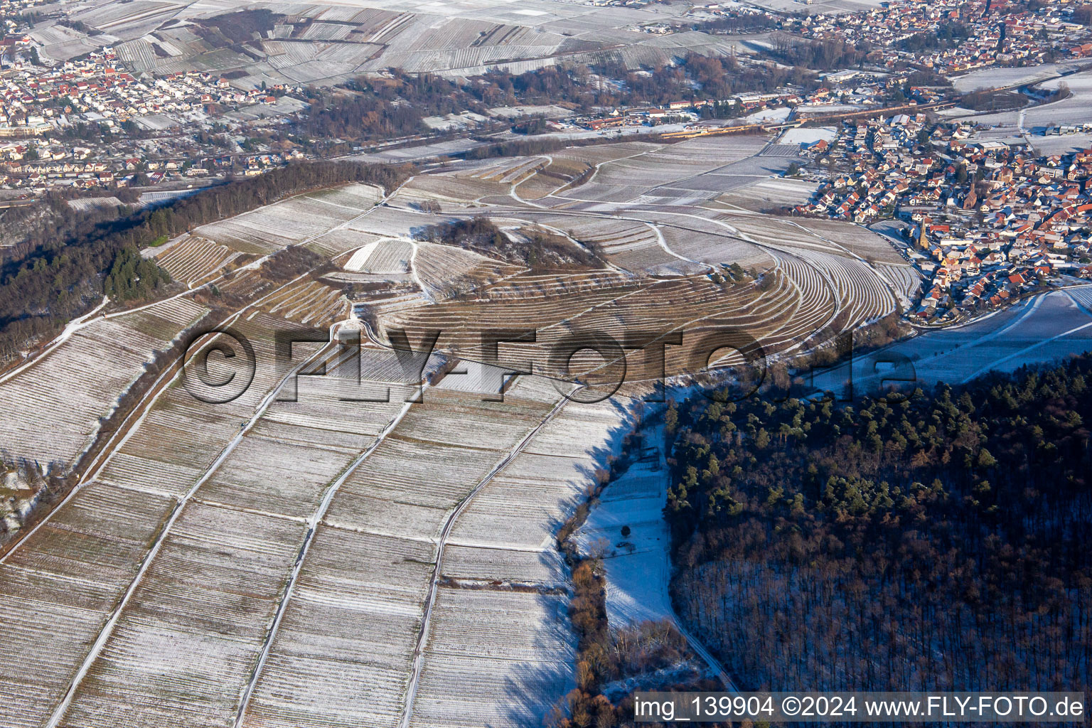 Oblique view of Keschdebusch vineyard from the west in winter with snow in Birkweiler in the state Rhineland-Palatinate, Germany