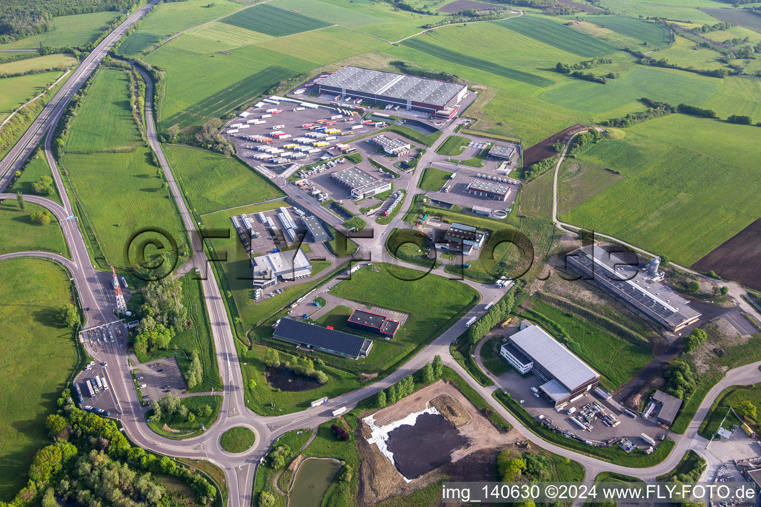 Aerial view of Industrial area with KIMMEL LOGISTIK, KIMMEL LAVAGE, Dietrich Véhicules and Sarre Union Pl Services - MAN at the toll station Sarre-Union - A4 - Route N°42 in Thal-Drulingen in the state Bas-Rhin, France