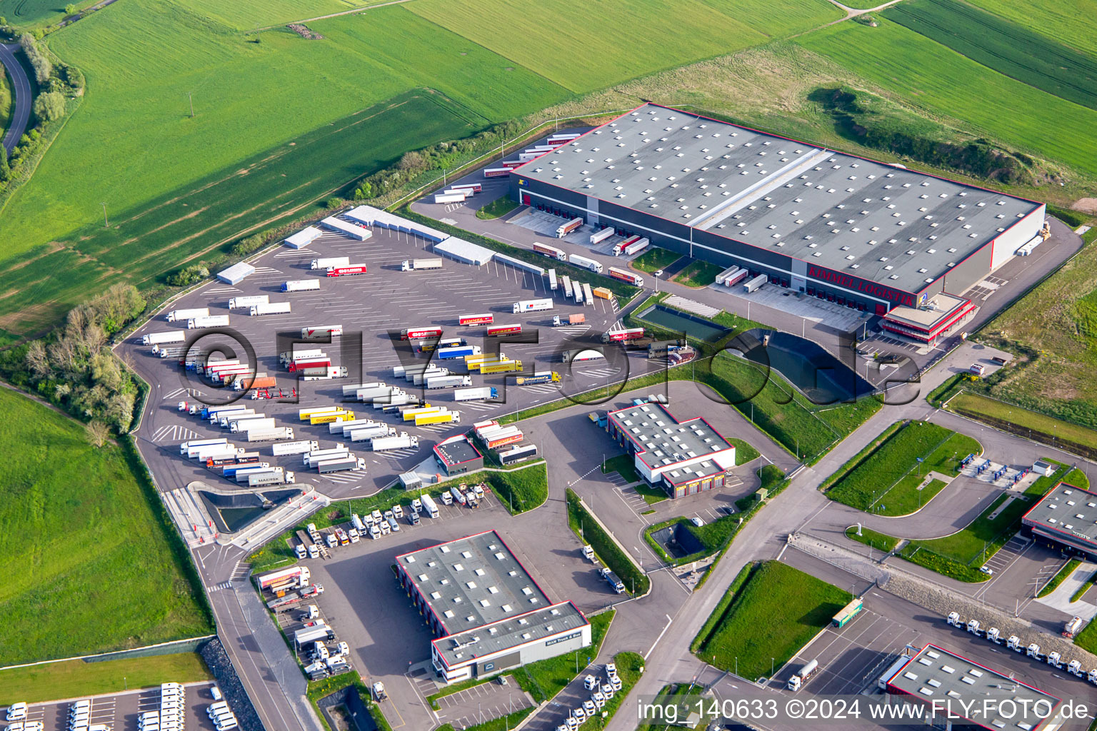 Industrial area with KIMMEL LOGISTIK, KIMMEL LAVAGE, Dietrich Véhicules and Sarre Union Pl Services - MAN at the toll station Sarre-Union - A4 - Route N°42 in Thal-Drulingen in the state Bas-Rhin, France from above