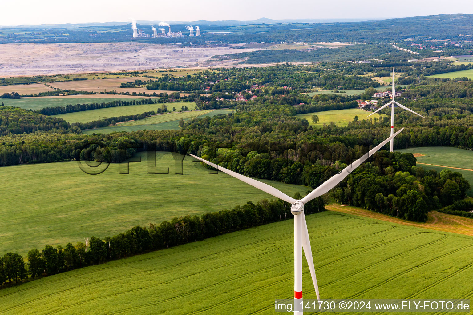 Czech wind farm Wetzwalde (Větrný park Václavice) in front of the Polish brown coal open-cast mine Kopalnia Węgla Brunatnego Turów in Hrádek nad Nisou in the state Liberec, Czech Republic