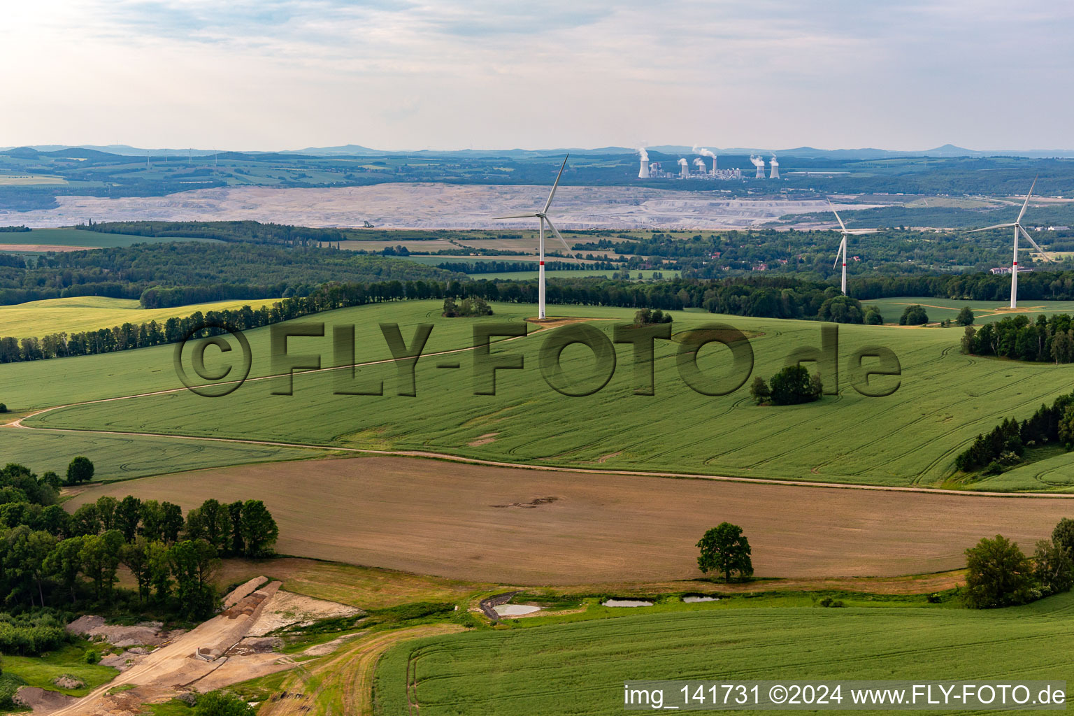 Aerial view of Czech wind farm Wetzwalde (Větrný park Václavice) in front of the Polish brown coal open-cast mine Kopalnia Węgla Brunatnego Turów in Hrádek nad Nisou in the state Liberec, Czech Republic