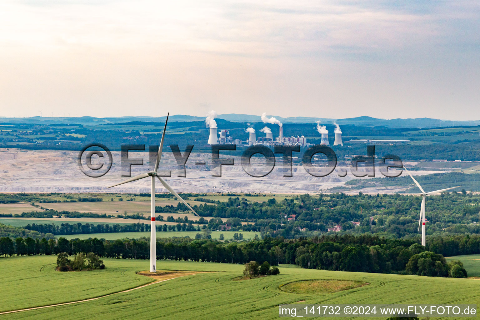 Aerial photograpy of Czech wind farm Wetzwalde (Větrný park Václavice) in front of the Polish brown coal open-cast mine Kopalnia Węgla Brunatnego Turów in Hrádek nad Nisou in the state Liberec, Czech Republic