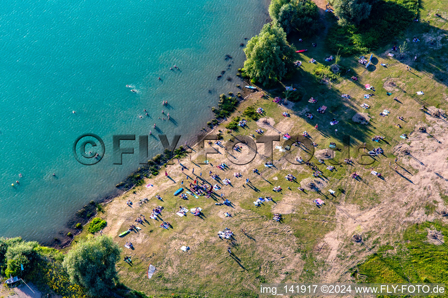 Many bathers on the lawn at Epplesee in the district Silberstreifen in Rheinstetten in the state Baden-Wuerttemberg, Germany