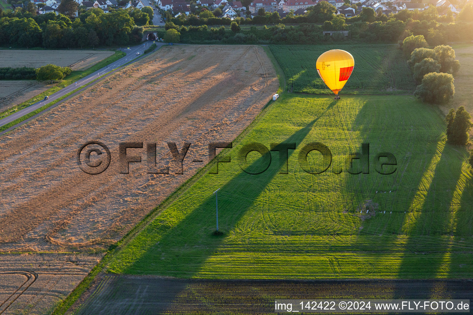 Landing of two hot air balloons "Pfalzgas in Winden in the state Rhineland-Palatinate, Germany from above