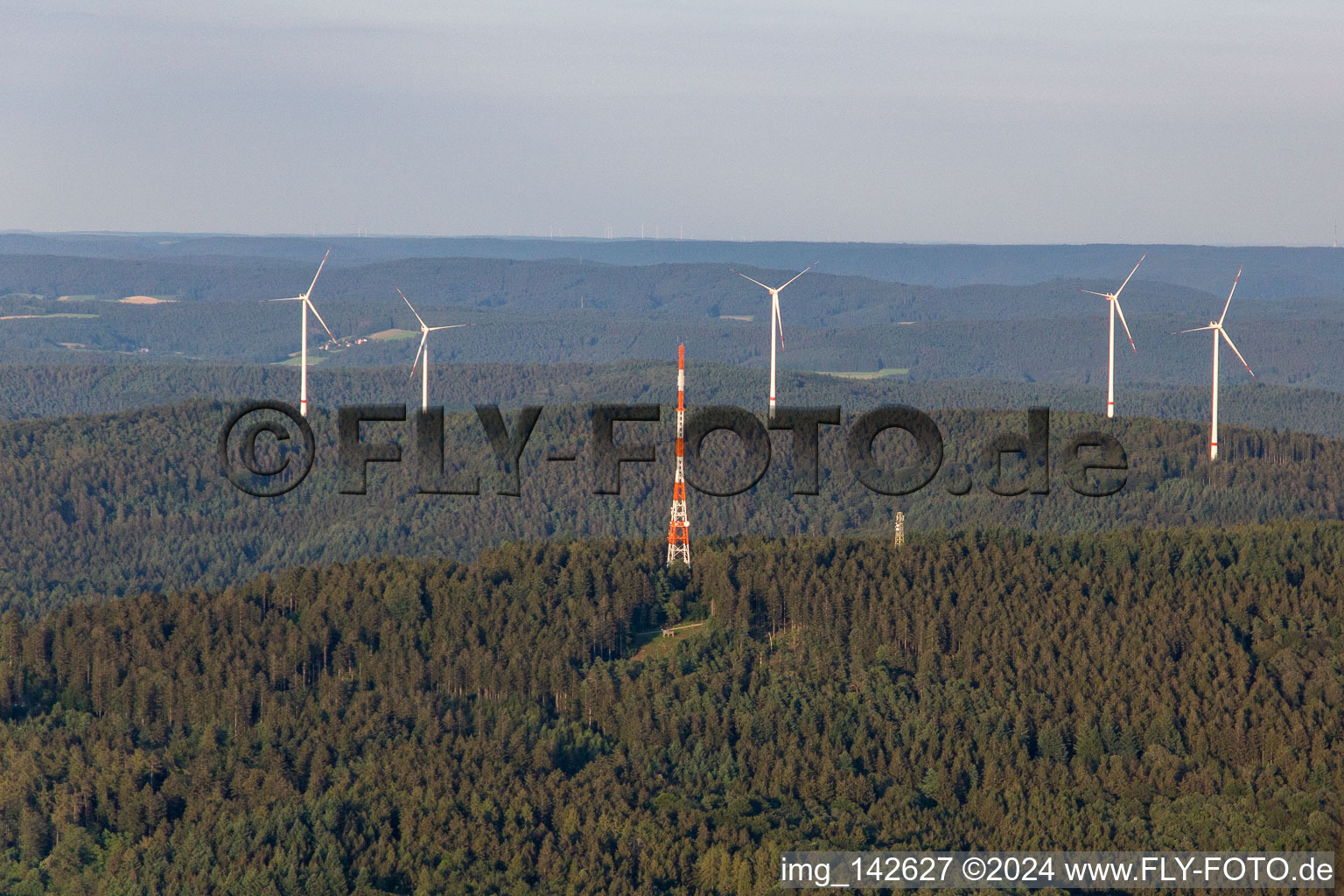 Mast of the Hardberg television transmitter in front of the Stillfüssel wind farm in the district Ober-Abtsteinach in Abtsteinach in the state Hesse, Germany