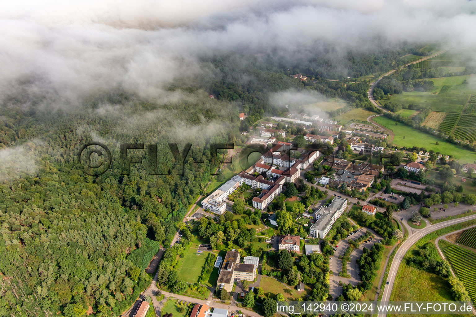 Thick clouds over the Palatinate Hospital for Psychiatry and Neurology in Klingenmünster in the state Rhineland-Palatinate, Germany from the plane