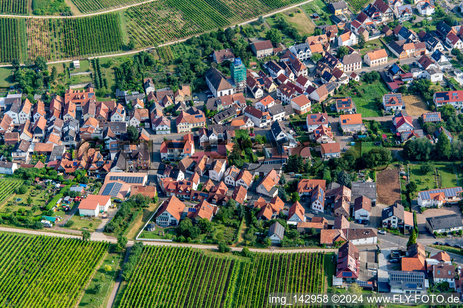 Village from the south with scaffolded Catholic parish and pilgrimage church of All Saints in Ranschbach in the state Rhineland-Palatinate, Germany