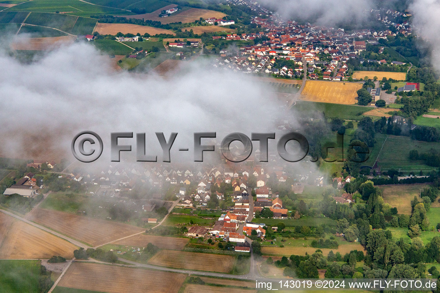 Village hidden under clouds from the east in the district Mühlhofen in Billigheim-Ingenheim in the state Rhineland-Palatinate, Germany