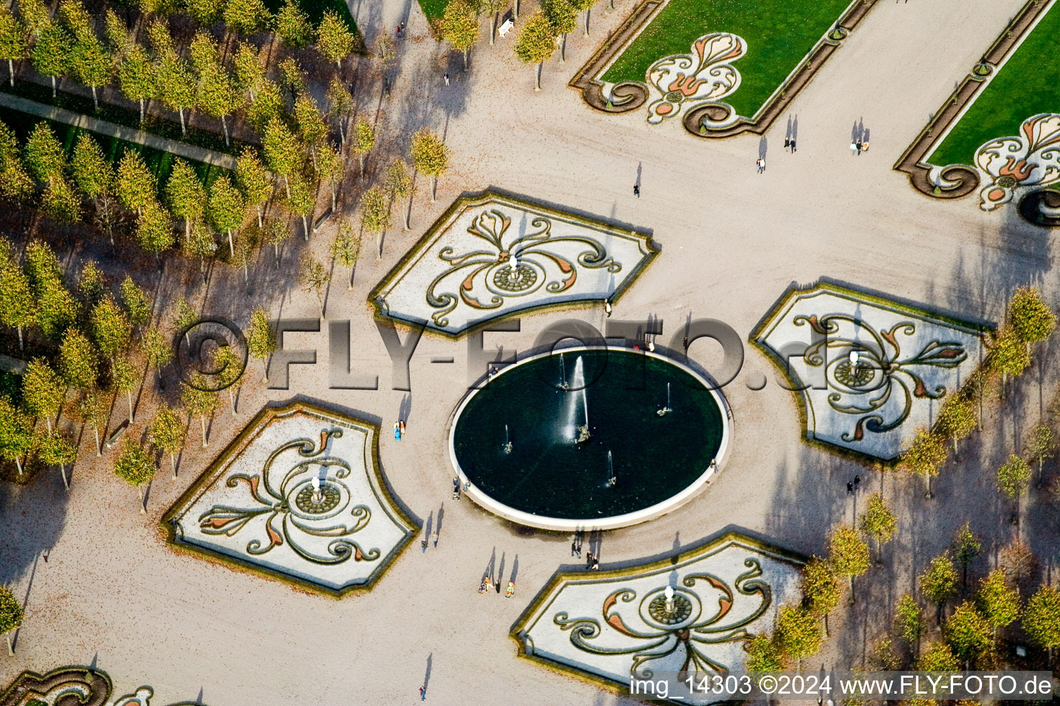 Flowers and spring fountain in the center of the park of the baroque castle Schloss Schwetzingen in Schwetzingen in the state Baden-Wurttemberg