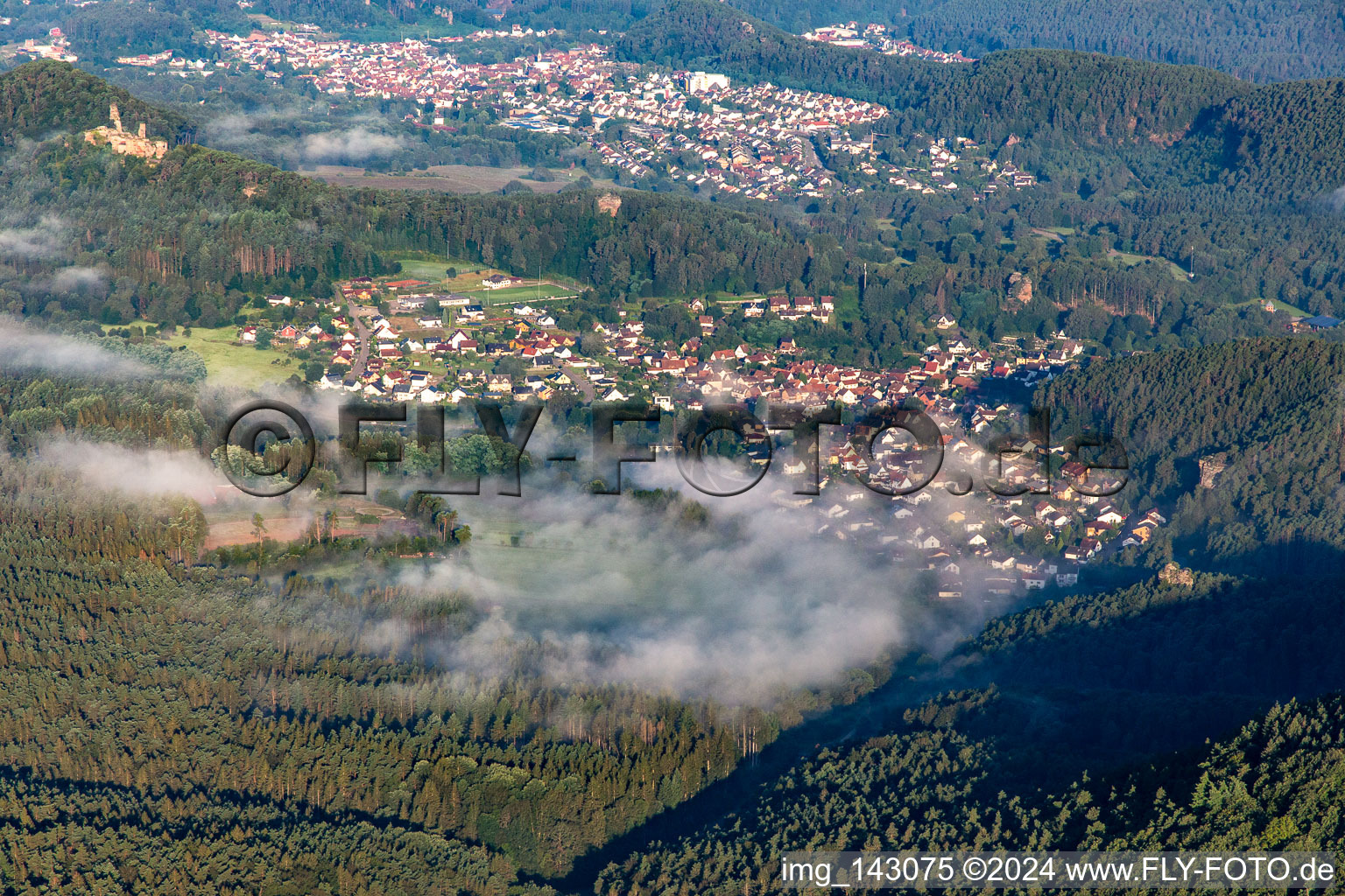 Village in the morning mist from the east in Schindhard in the state Rhineland-Palatinate, Germany