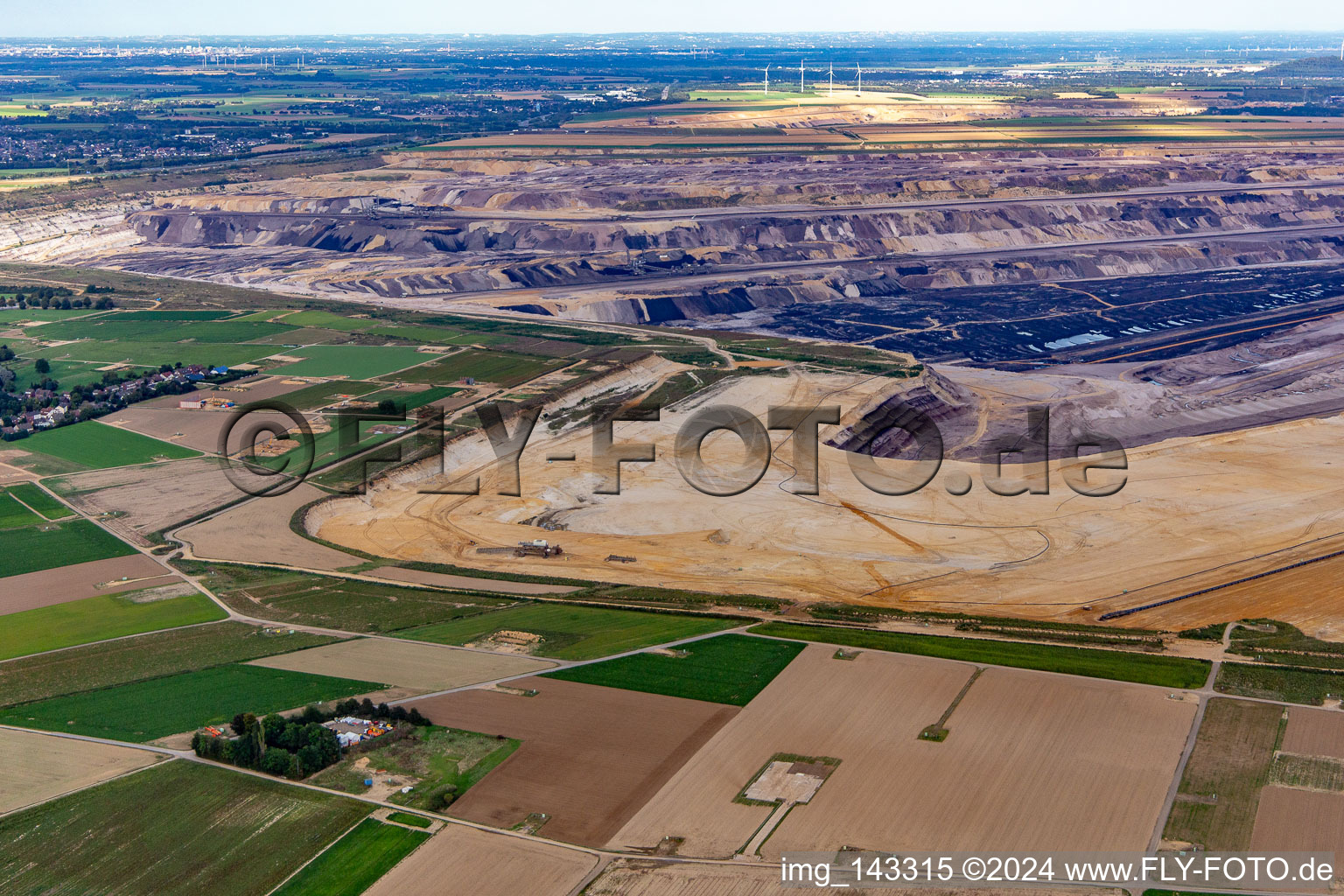 View of the Garzweiler open-cast lignite mine from the west in the district Keyenberg in Erkelenz in the state North Rhine-Westphalia, Germany