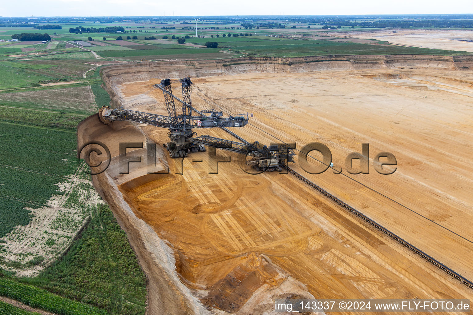 Bird's eye view of Giant hoisting crane eats into former farmland for the western expansion of the Garzweiler open-cast lignite mine in the district Immerath in Erkelenz in the state North Rhine-Westphalia, Germany