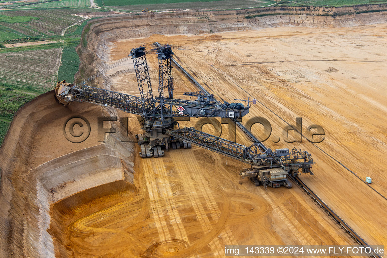 Giant hoisting crane eats into former farmland for the western expansion of the Garzweiler open-cast lignite mine in the district Immerath in Erkelenz in the state North Rhine-Westphalia, Germany viewn from the air