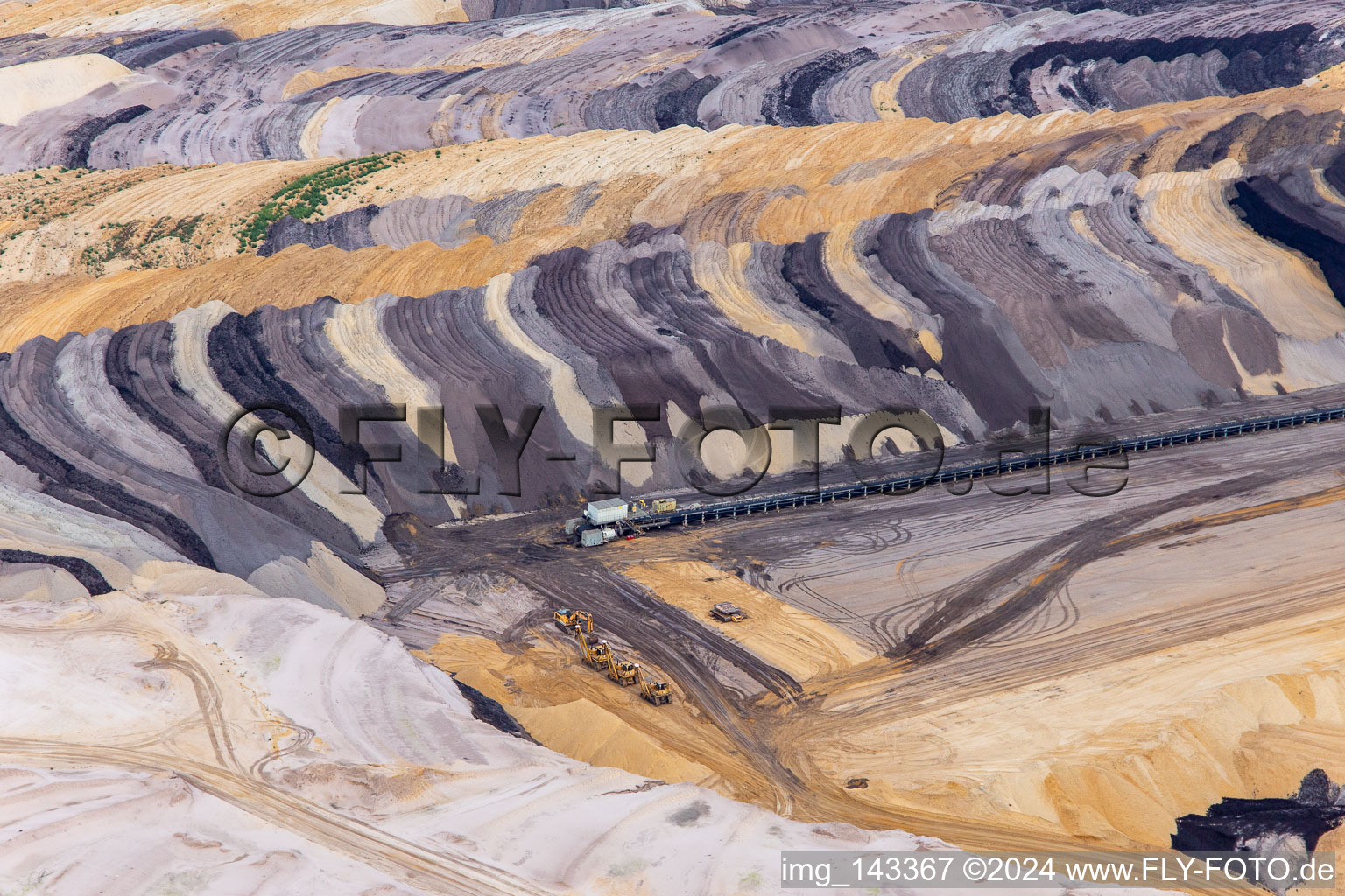 Interestingly colored layers of overburden and coal in the Garzweiler opencast lignite mine in the district Borschemich in Erkelenz in the state North Rhine-Westphalia, Germany out of the air