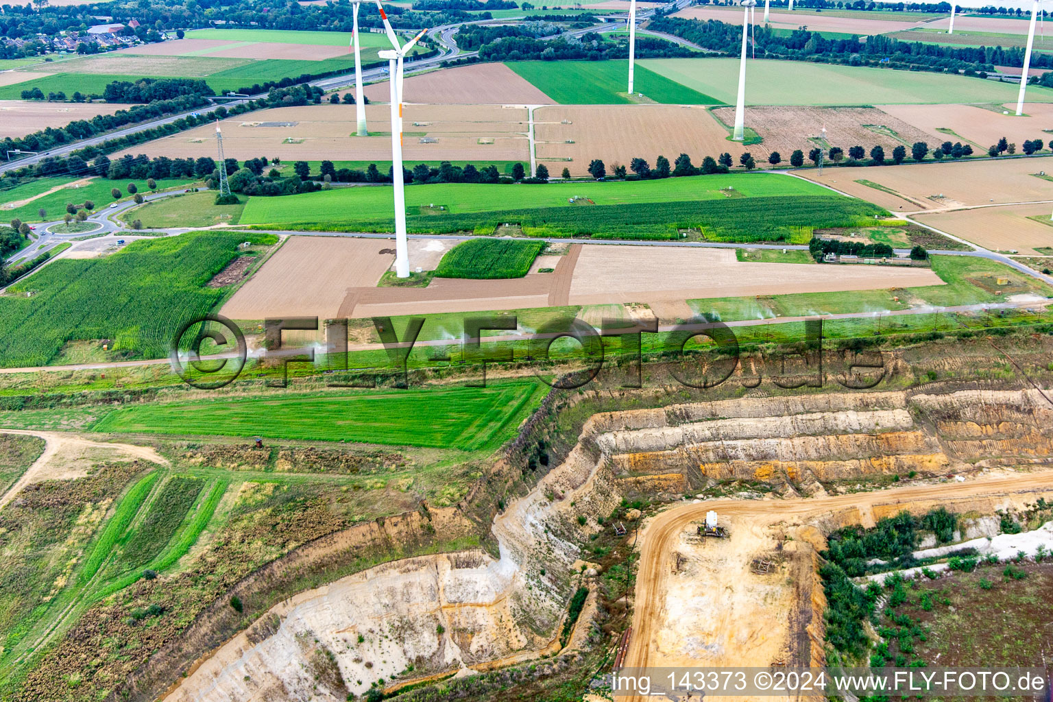 Water sprayer on the fence for dust reduction at the northern edge of the Garzweiler open-cast lignite mine in the district Wanlo in Mönchengladbach in the state North Rhine-Westphalia, Germany