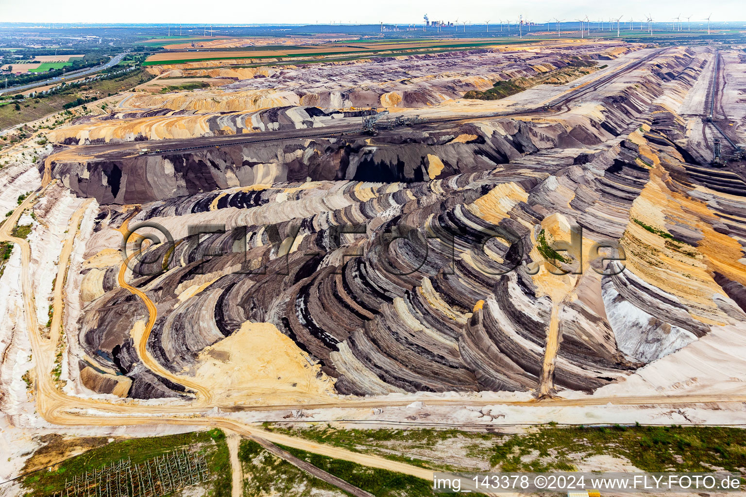 Drone recording of Interestingly colored layers of overburden and coal in the Garzweiler opencast lignite mine in the district Borschemich in Erkelenz in the state North Rhine-Westphalia, Germany