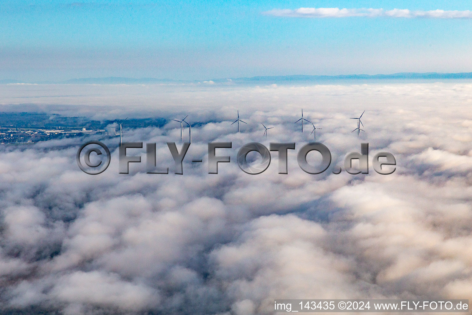 Rotors of the wind farm near Offenbach rise above the low clouds in Offenbach an der Queich in the state Rhineland-Palatinate, Germany