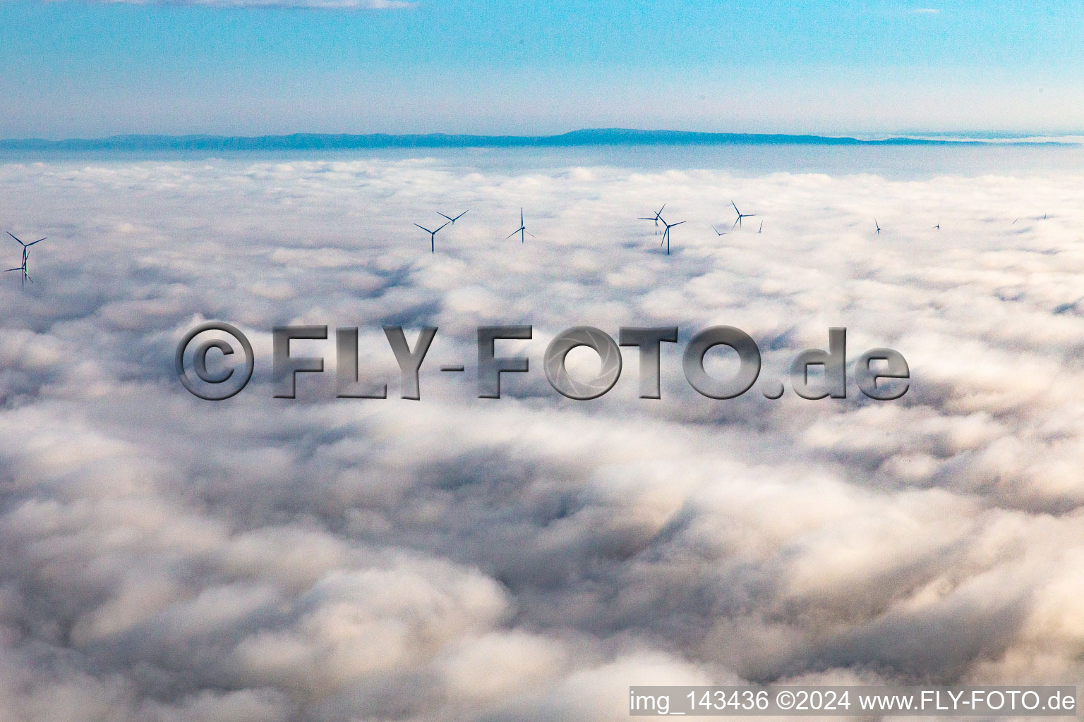 Aerial view of Rotors of the wind farm near Offenbach rise above the low clouds in Offenbach an der Queich in the state Rhineland-Palatinate, Germany