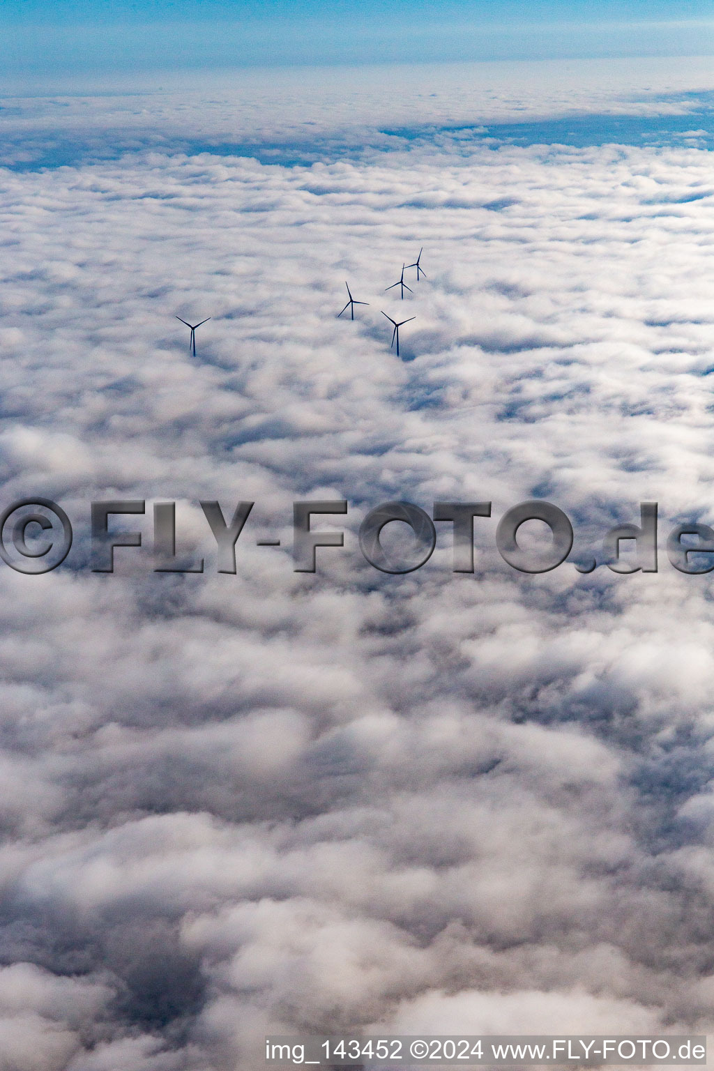 Rotors of the wind farm at Hatzenbühl rise above the low clouds in Hatzenbühl in the state Rhineland-Palatinate, Germany