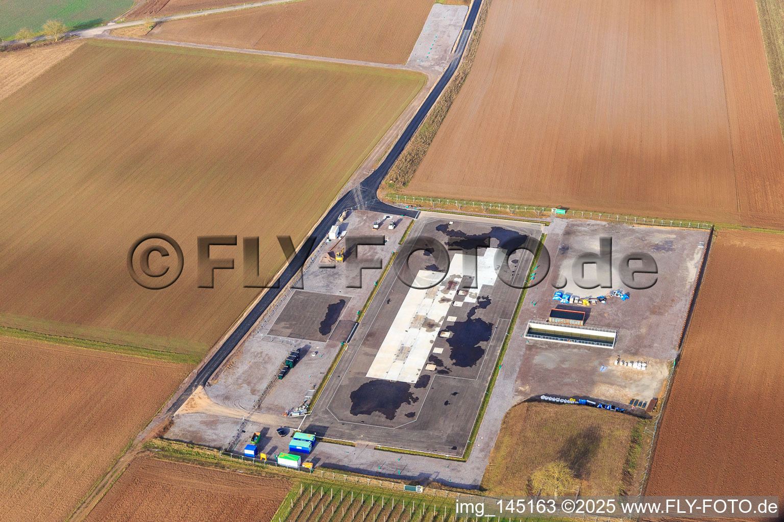 Construction site of the V20 deep drilling site of Vulcan Energy at Schleidberg for the extraction of geothermal energy and lithium in Insheim in the state Rhineland-Palatinate, Germany viewn from the air