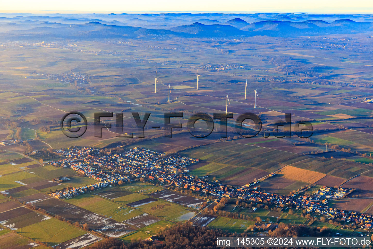 Wind farm in winter with a distant view over the Palatinate Forest in Freckenfeld in the state Rhineland-Palatinate, Germany
