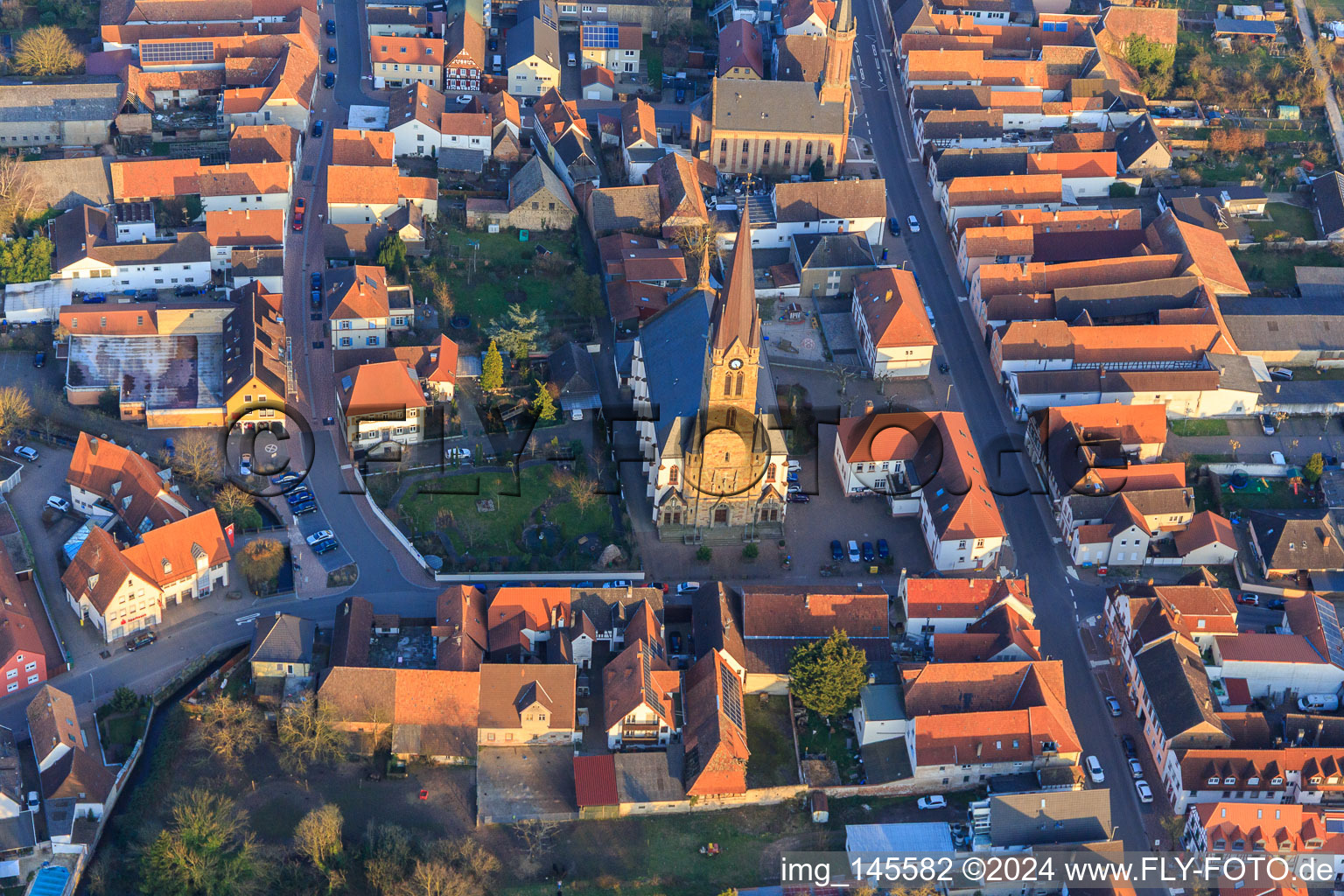 Aerial view of Catholic Church of St. Nicholas and Protestant Church Bellheim on Hauptstr in Bellheim in the state Rhineland-Palatinate, Germany