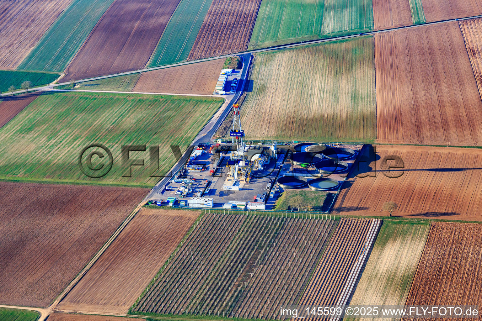 Drilling rig of the V20 deep drilling site of Vulcan Energy at Schleidberg for the extraction of geothermal energy and lithium in Insheim in the state Rhineland-Palatinate, Germany viewn from the air