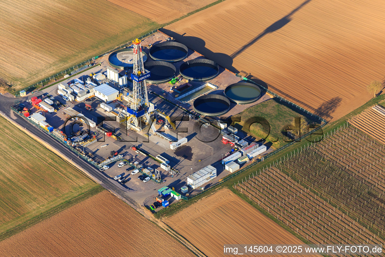 Drilling rig of the V20 deep drilling site of Vulcan Energy at Schleidberg for the extraction of geothermal energy and lithium in Insheim in the state Rhineland-Palatinate, Germany from the drone perspective