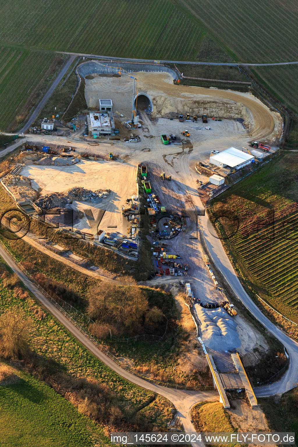 Construction site of the eastern tunnel portal for the Astrid Tunnel for the underpass and bypass of Bad Bergzabern between B38 (Weinstraße) and B427 (Kurtalstraße) in Dörrenbach in the state Rhineland-Palatinate, Germany from the plane