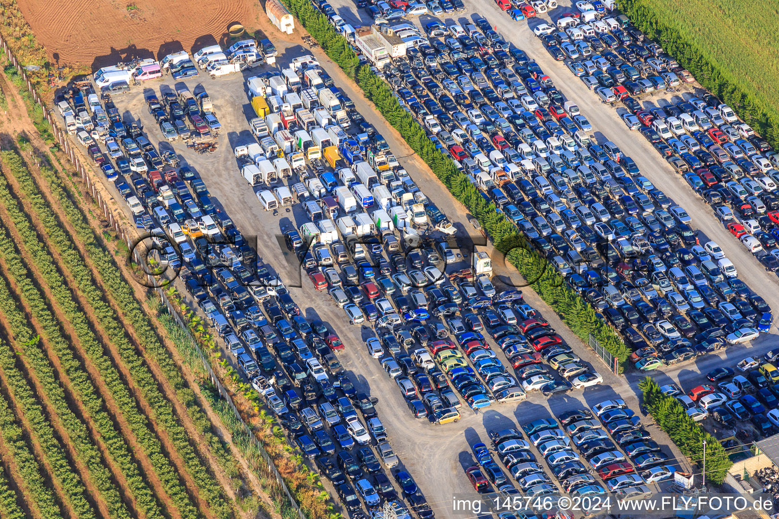 Aerial photograpy of Rows of stacked old vehicles at the Desguace Siglo 21 scrapyard in Dos Hermanas in the state Seville, Spain