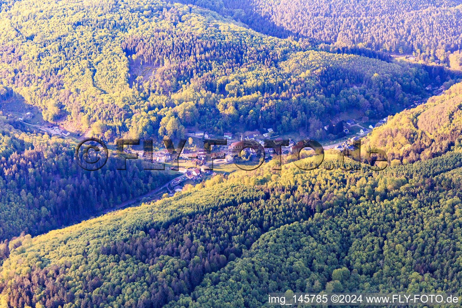 Village view in the evening in a valley of the Northern Vosges from the southeast in Soucht in the state Moselle, France