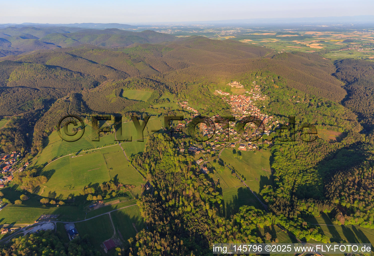 Oblique view of View of the village in the Northern Vosges from the west below the Château de Lichtenberg in Lichtenberg in the state Bas-Rhin, France